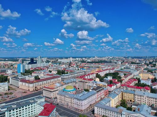Free Aerial photo showcasing the vibrant cityscape of Minsk, Belarus under a clear blue sky. Stock Photo