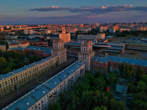 Free Aerial view of Minsk, Belarus cityscape with iconic architecture under a vibrant sunset sky. Stock Photo