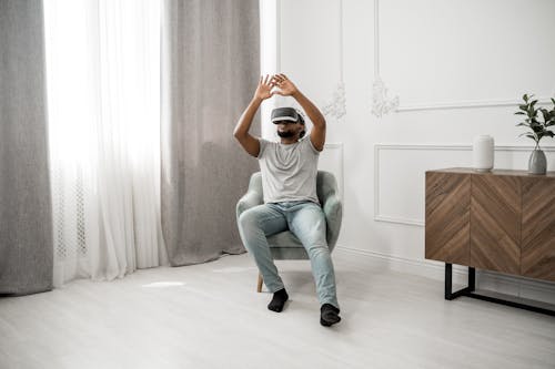 Man in Gray Crew Neck T-shirt Wearing White and Black Vr Goggles