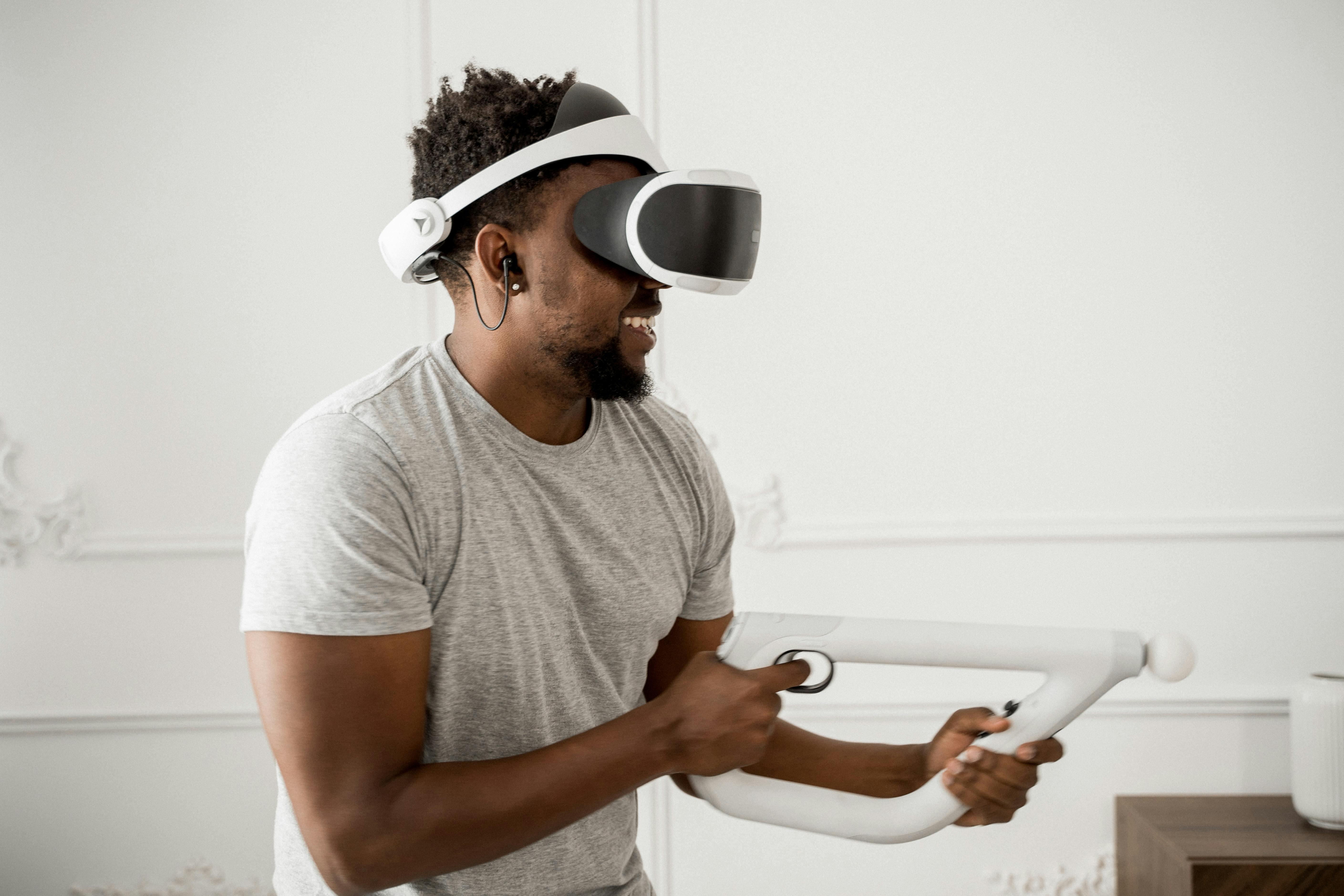 man in gray crew neck t shirt wearing white and black vr goggles