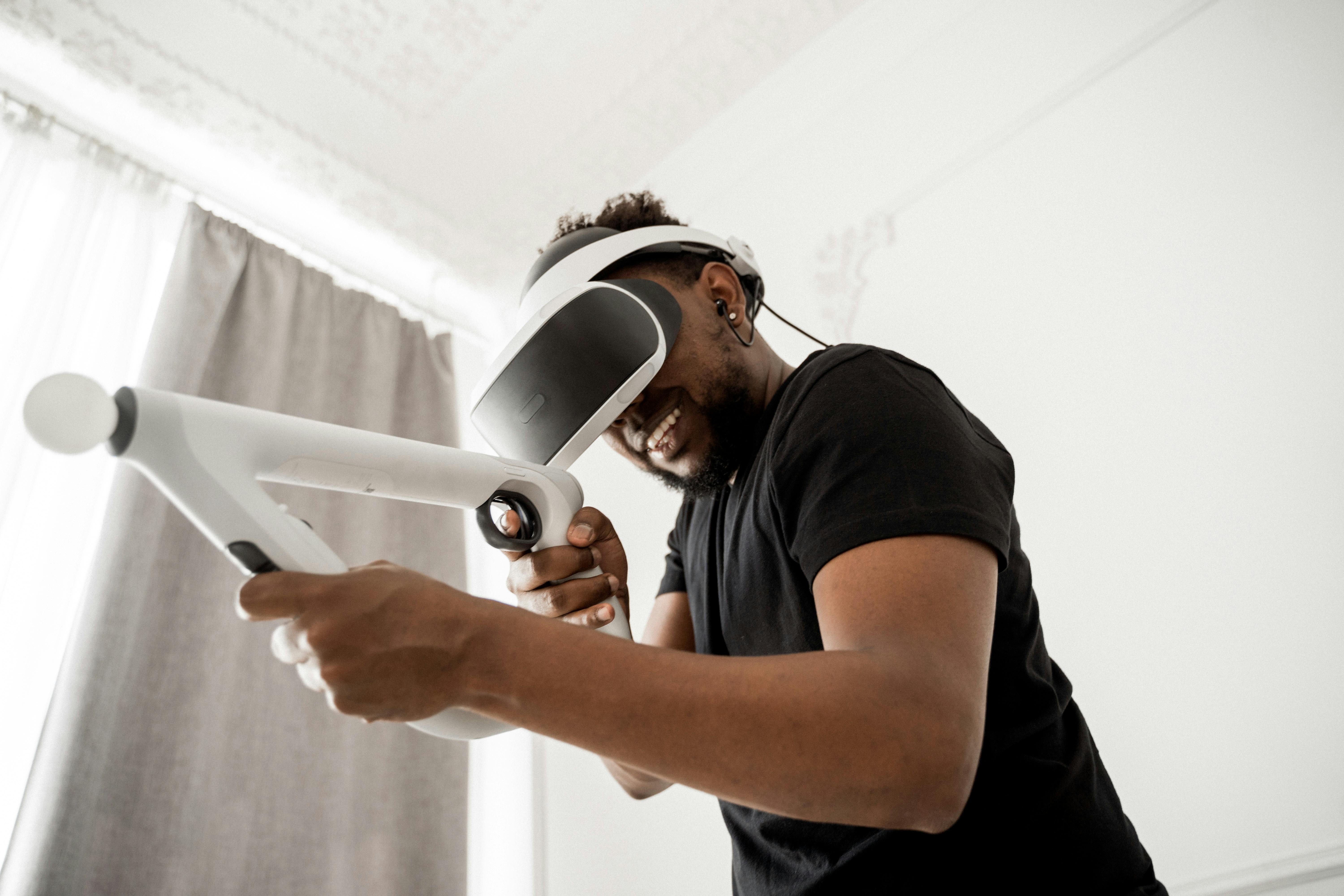 man in black crew neck t-shirt wearing white and black VR goggles