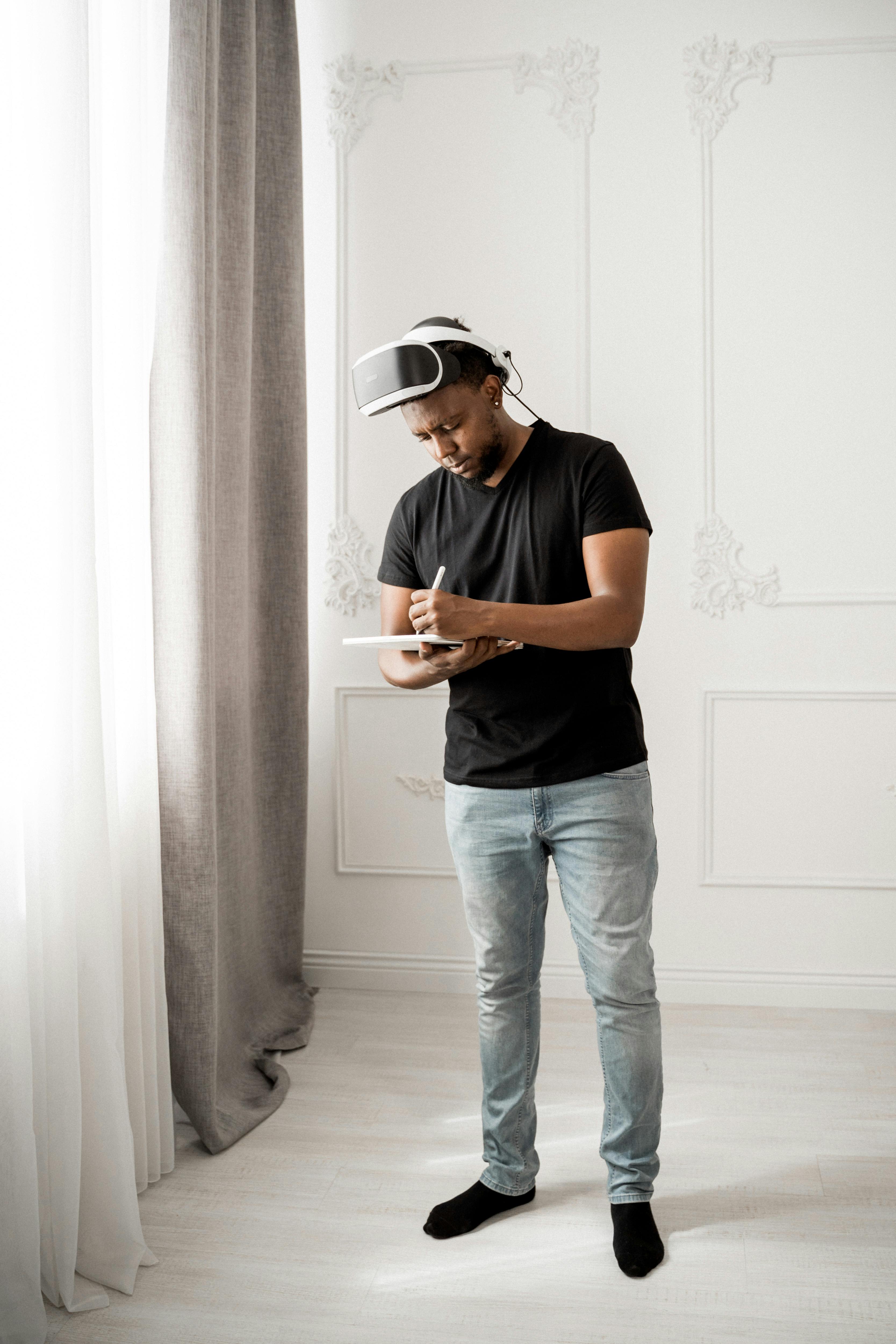 man in black crew neck t shirt wearing white and black vr goggles