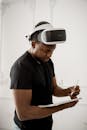 Man in Black Crew Neck T-shirt Wearing White and Black Vr Goggles