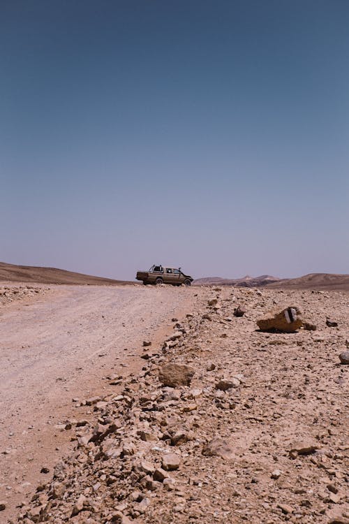 Car on road in desert terrain