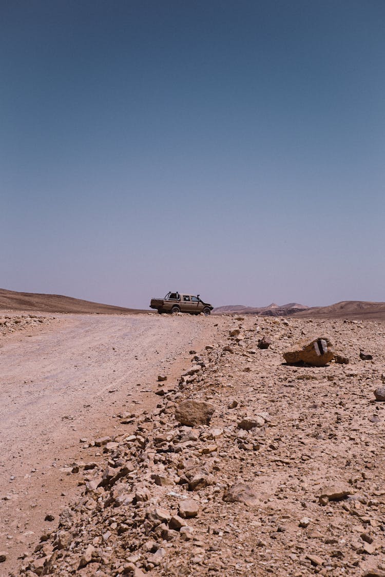 Car On Road In Desert Terrain