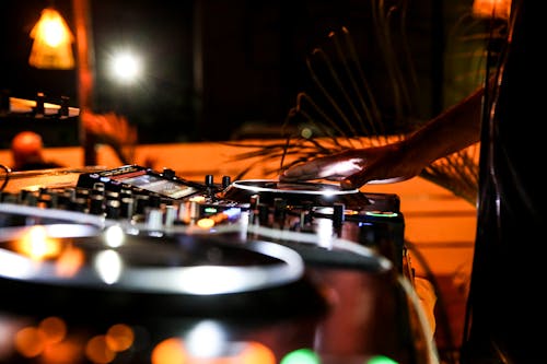 A Person Playing music on a Dj Mixer
