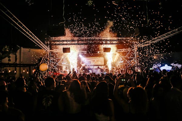 Live concert at night with enthusiastic crowd