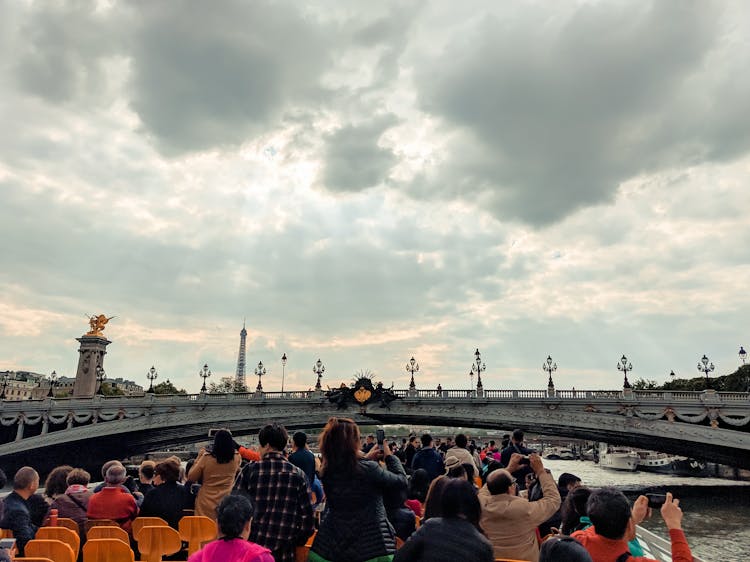 Tourists On A Boat Photographing The Pont Alexandre III In Paris