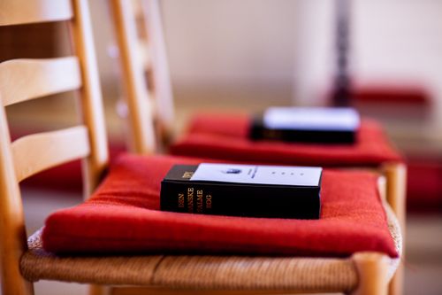 Free Chairs with cushions and Danish hymnals create an inviting liturgical space. Stock Photo