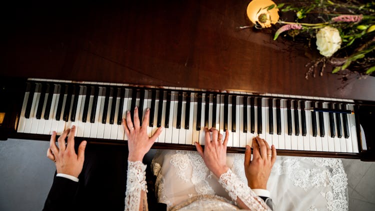 Male And Female Hands On Piano