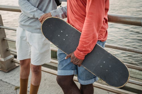 Young diverse friends standing close on waterfront