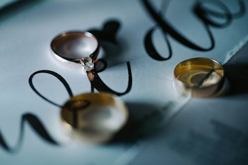 Golden rings on white sheet