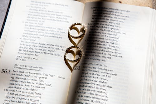 Free Gold Ring on Book Page Stock Photo