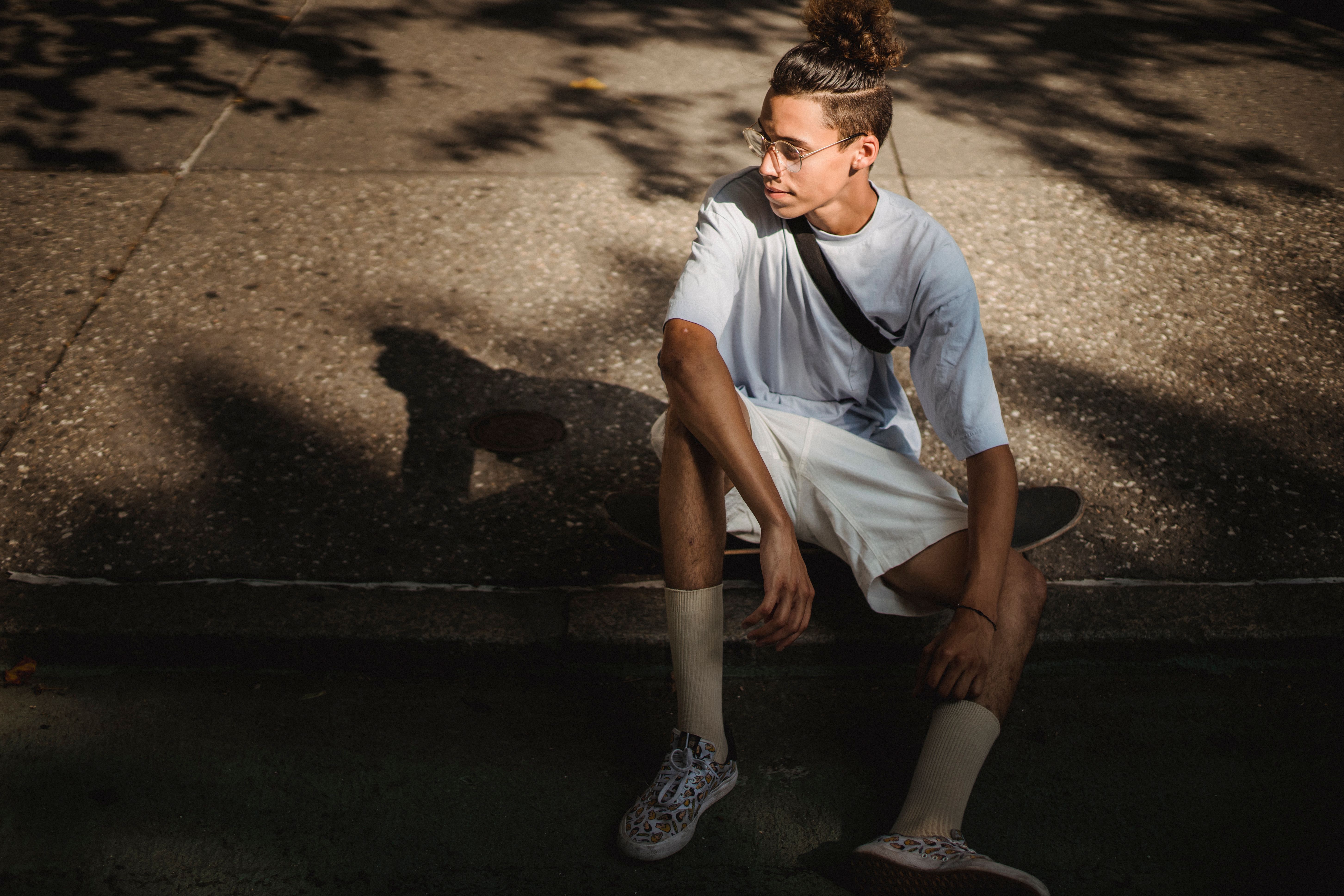Person sitting outside in early morning sunlight to reset circadian rhythm and sleep schedule