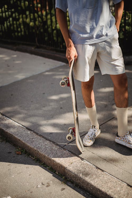 Female skater standing in street in day · Free Stock Photo