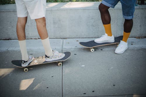 Free Skaters standing on sidewalk on street Stock Photo