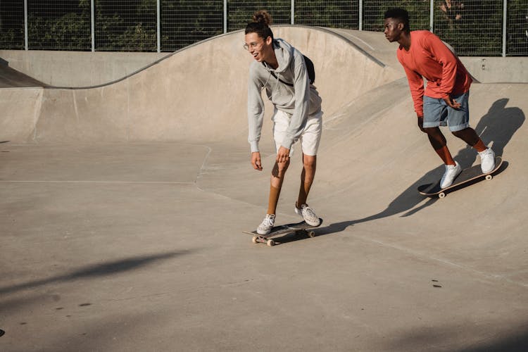 Active Man Smiling Men Balancing On Skateboards During Training On Ramp