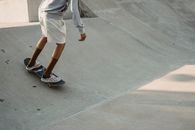 Man riding skateboard on ramp in city park