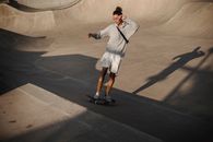 From above full body of determined male athlete riding skateboard on ramp during workout in skate park