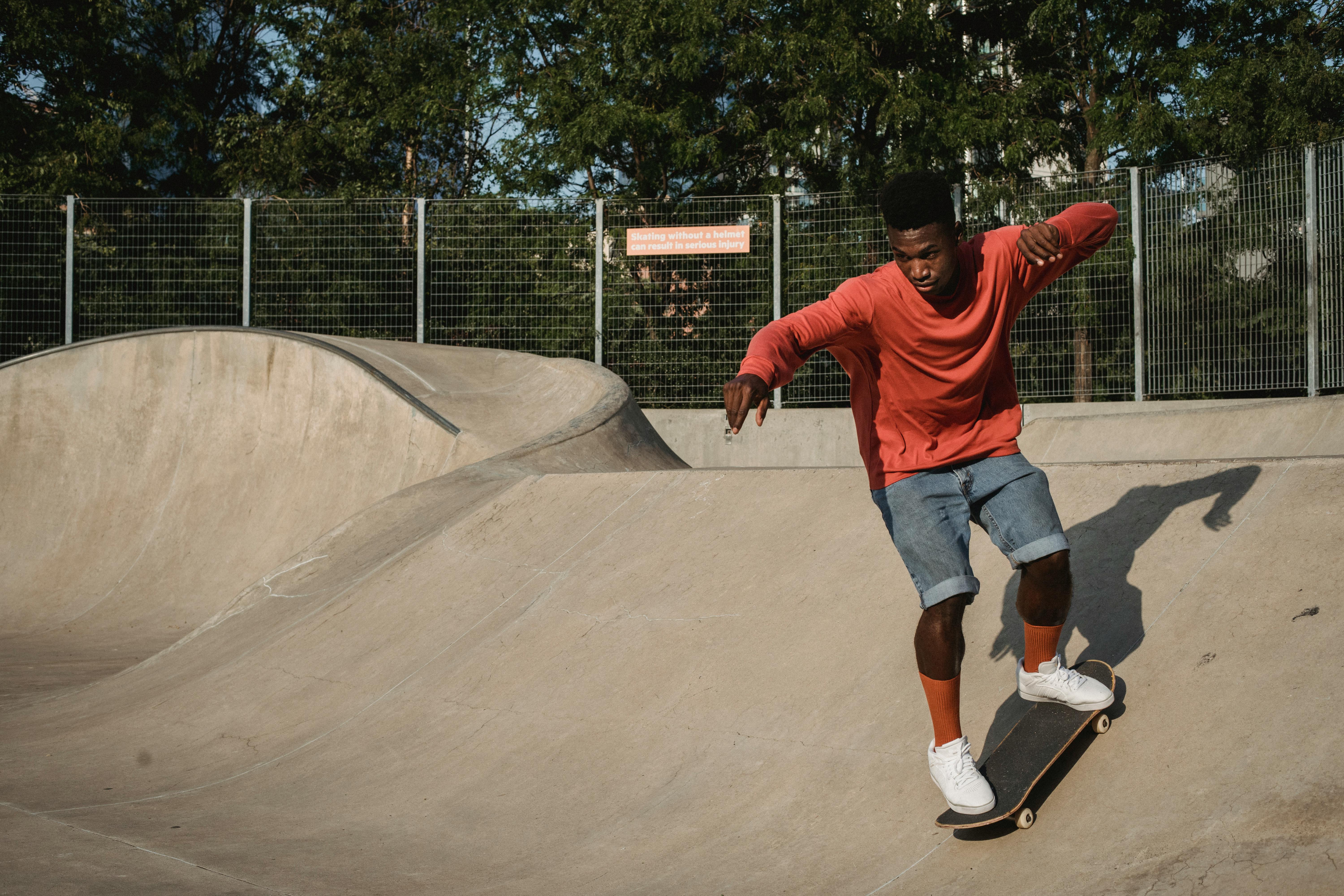 energetic black skateboarder practicing stunt on ramp