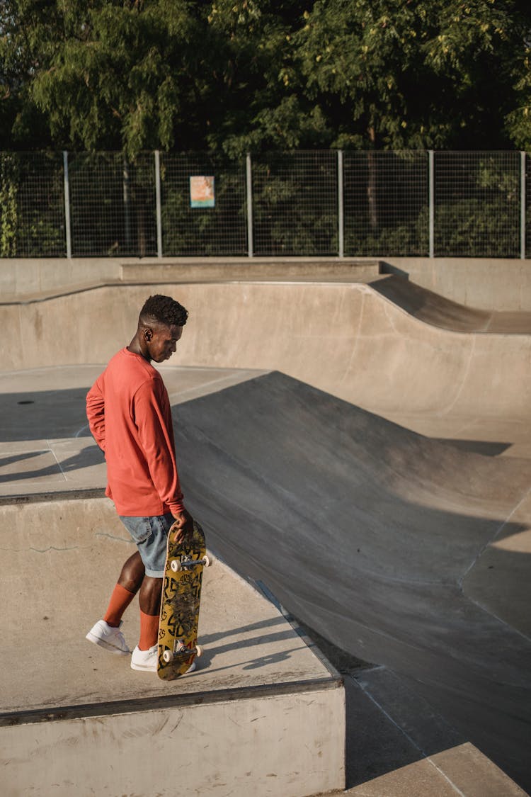 Young Man Holding A Skateboard