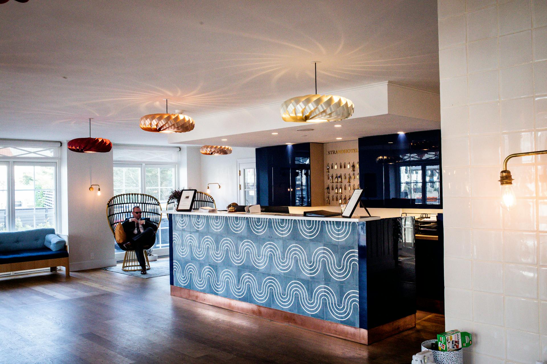 Elegant hotel lobby featuring a modern reception desk and designer lighting.