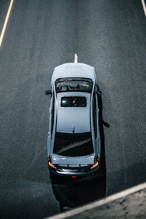 Modern car with luminous taillights driving on road