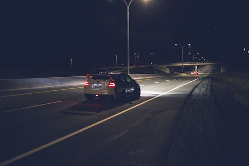 Car driving on asphalt roadway at hight