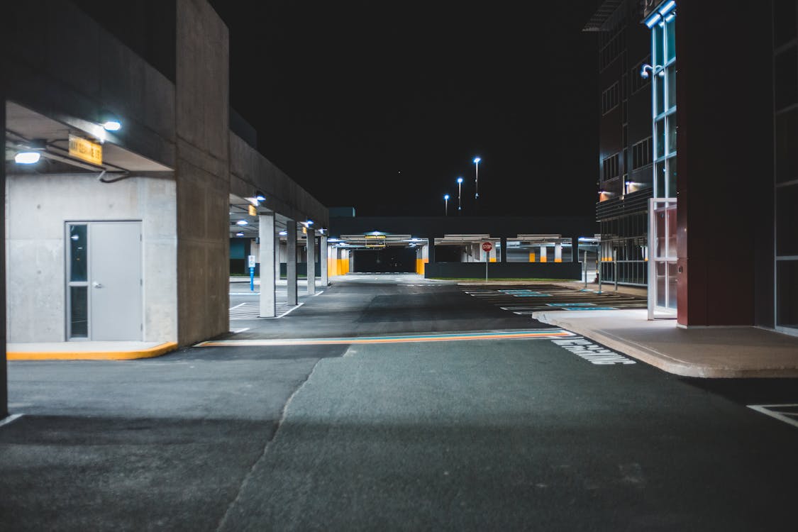 Free Illuminated Empty Parking Lot With Concrete Walls Stock Photo