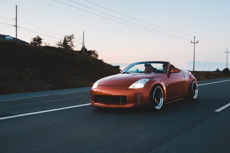 Stylish Cabriolet With Silver Wheels Driving On Highway