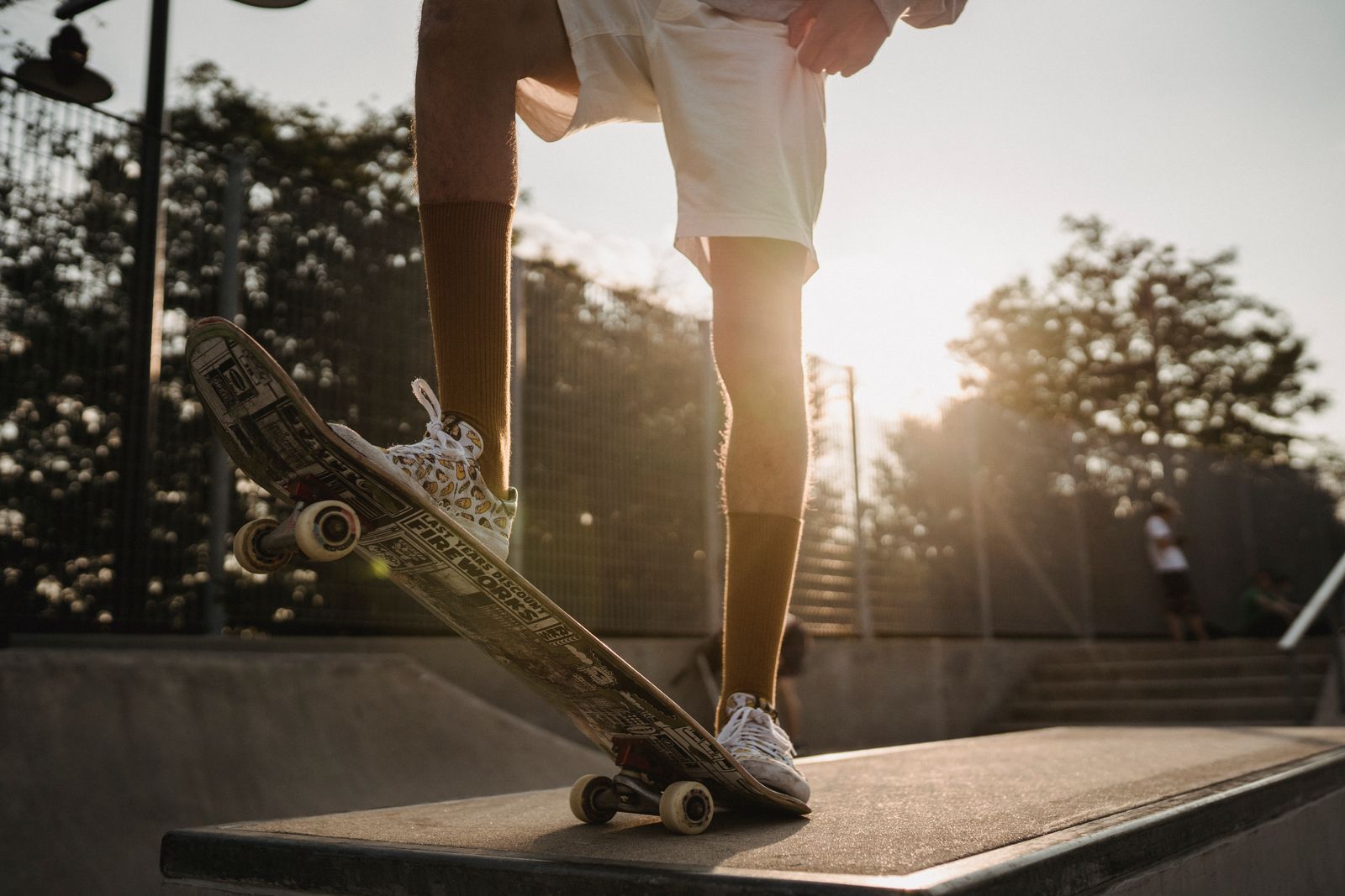 Runner stretching lower legs outdoors in bright daylight