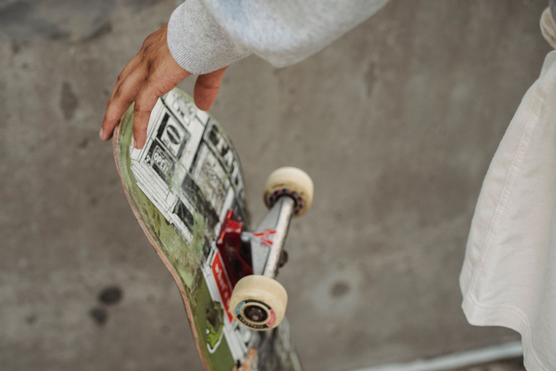 Collector inspecting a rare skateboard deck with magnifying glass in a quiet Austin vintage shop
