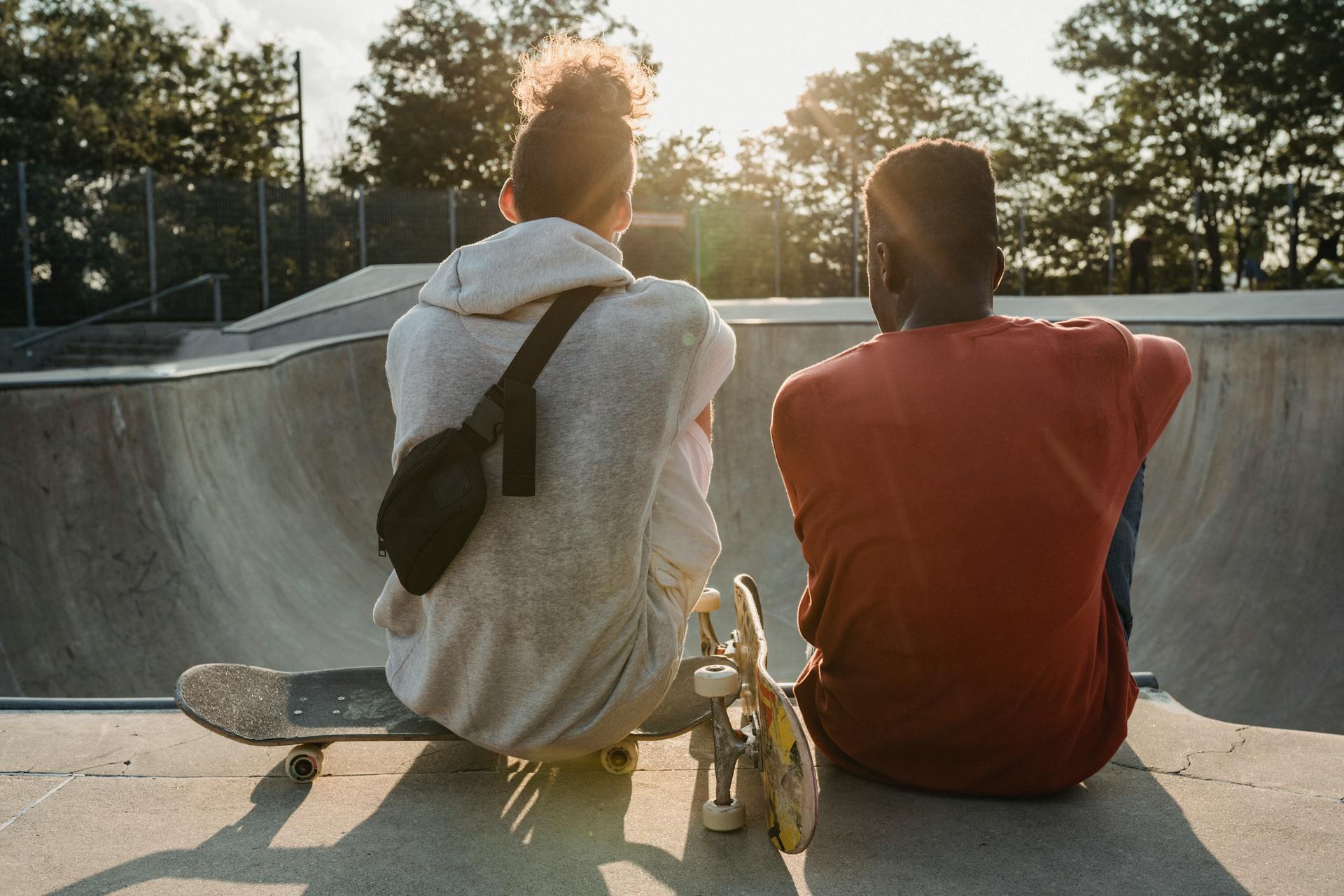 Diverse friends with skateboards on ramp