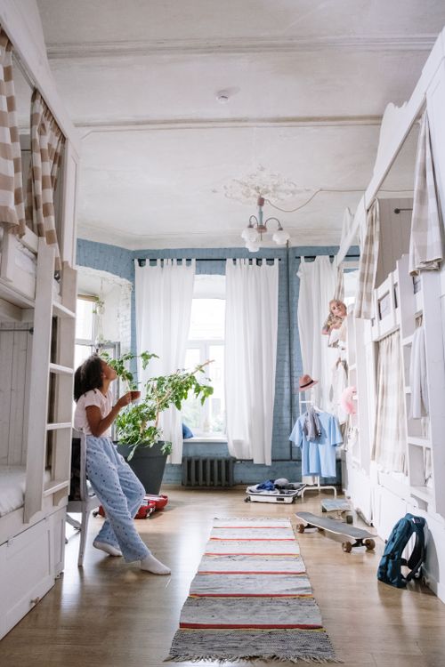 Free Light-filled dorm room with plants, bunk beds, and cozy decor. Stock Photo
