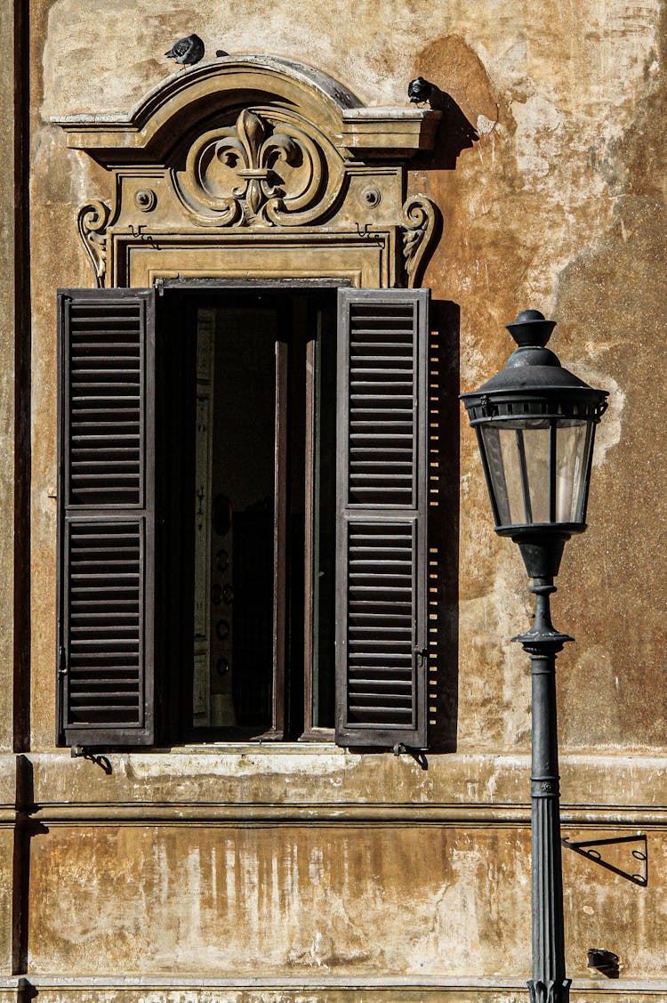 Close-up Of Old House Window With Shutters