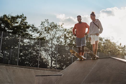 Full body of smiling multiracial male skaters in casual outfits standing on ramp and preparing to ride skateboards