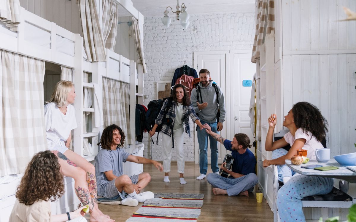 A diverse group of friends enjoying each other's company in a cozy dorm room, creating a warm and vibrant atmosphere.