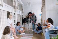 Group of People Sitting on Brown Wooden Floor