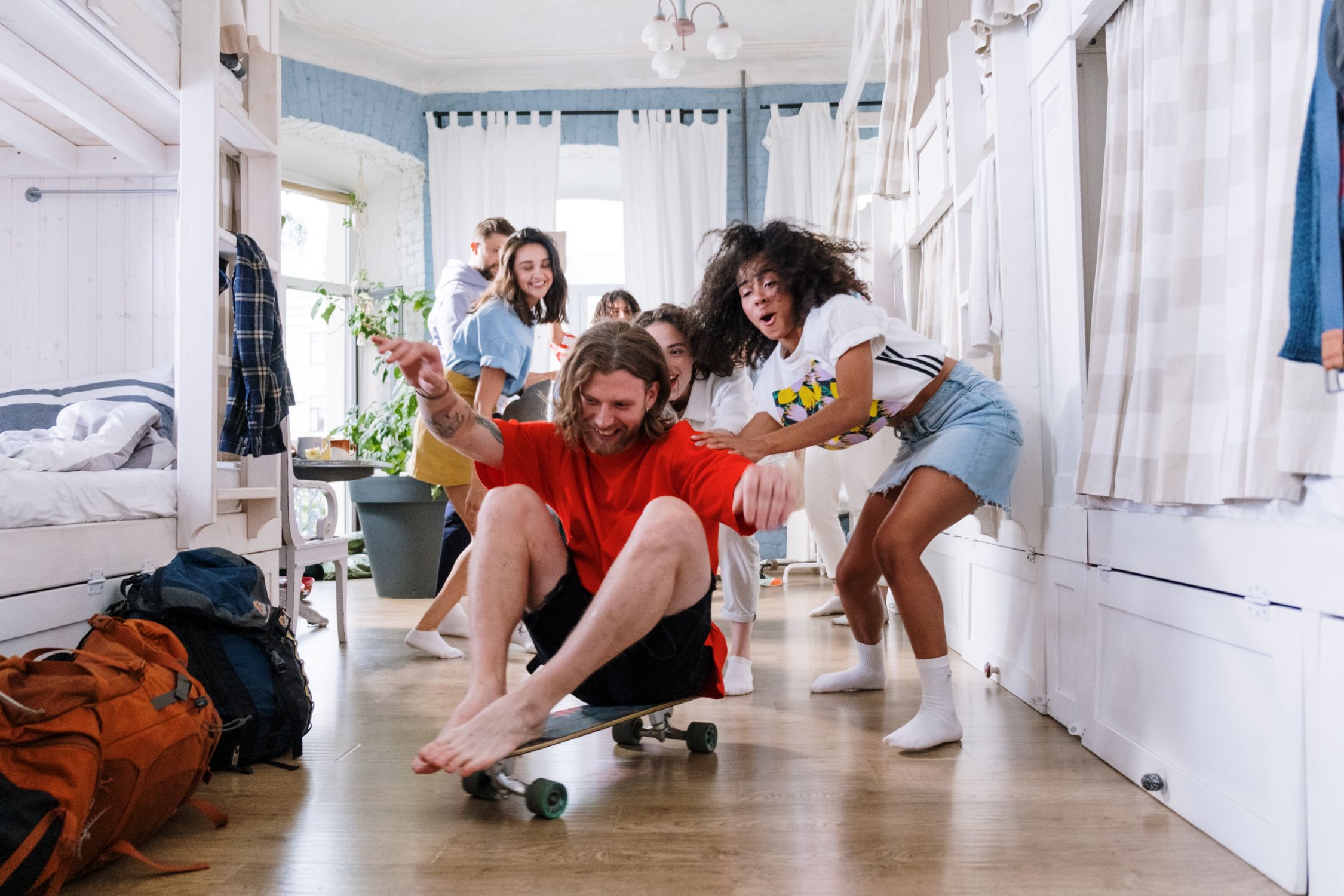 friends pushing someone on a skateboard