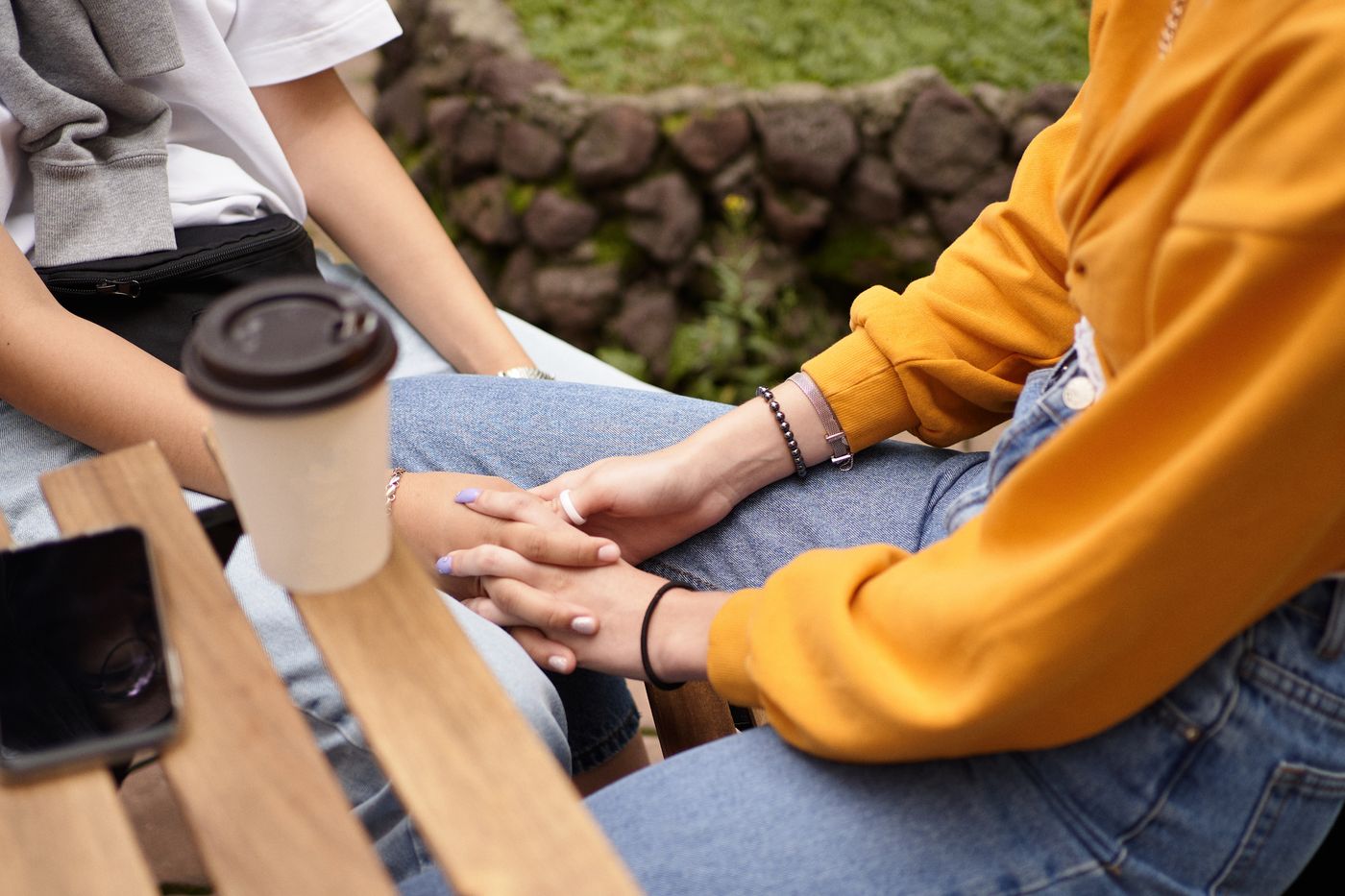 Friends holding hands in a moment of companionship