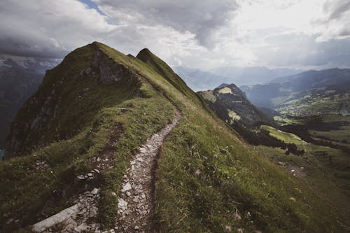 Green Grass Mountain Under White Clouds