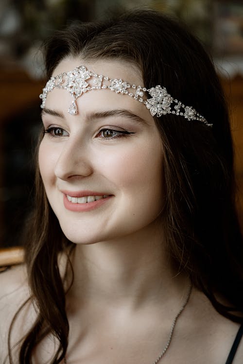Charming woman wearing diadem and smiling