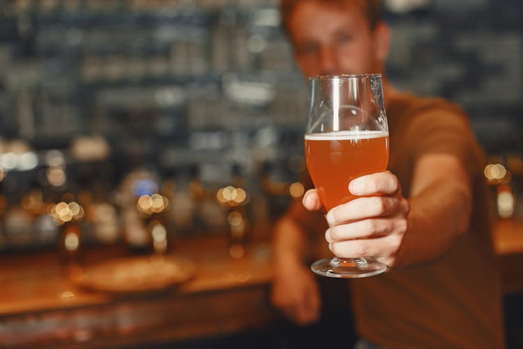 Man Holding Beer Glass In Hand