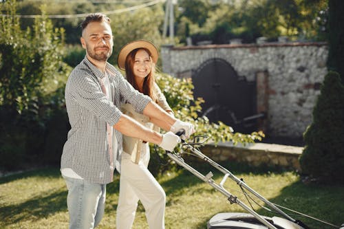 Free Man and Woman Holding Gray Grass Cutter Stock Photo