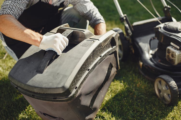 Man Replacing Grass Bag At Lawn Mower