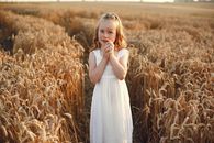 Woman in White Dress Standing on Wheat Field