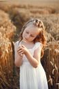 Girl in White Sleeveless Dress Standing on Brown Grass Field