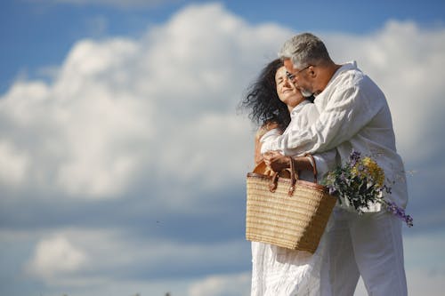 Free Woman in White Dress Carrying Brown Woven Basket Stock Photo