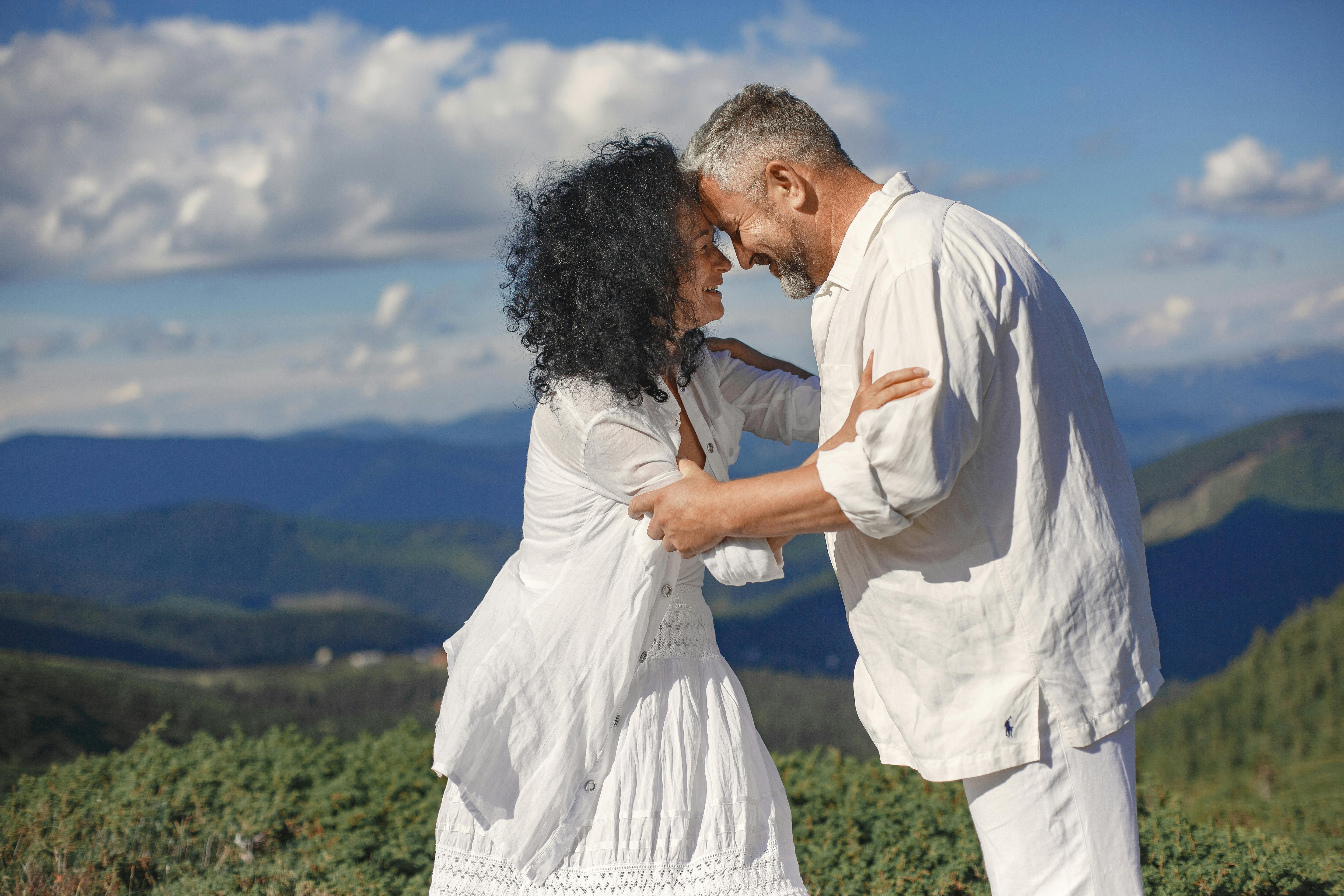 Mature couple embracing outdoors with mountain view