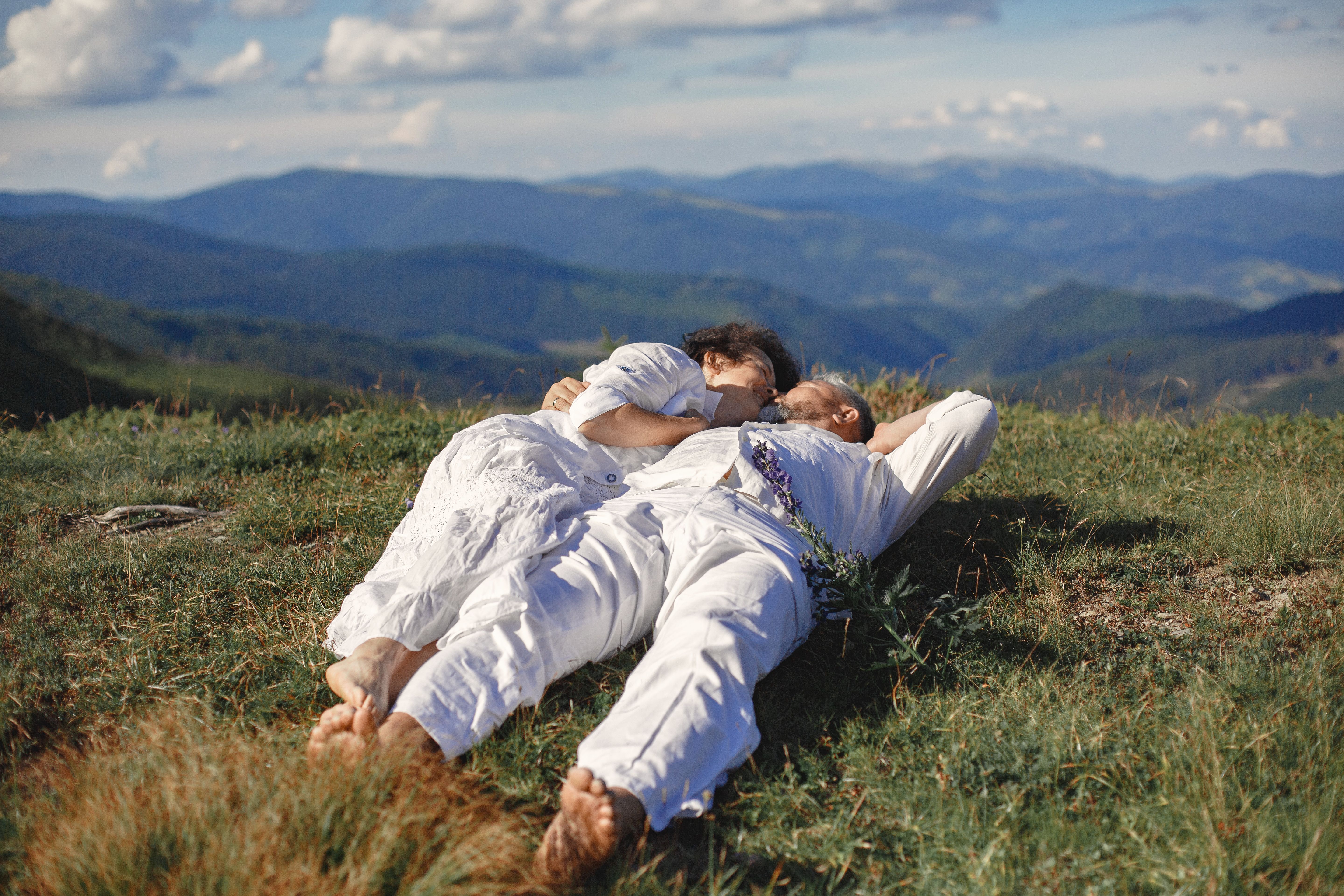 Man and Woman Lying on Green Grass Field · Free Stock Photo